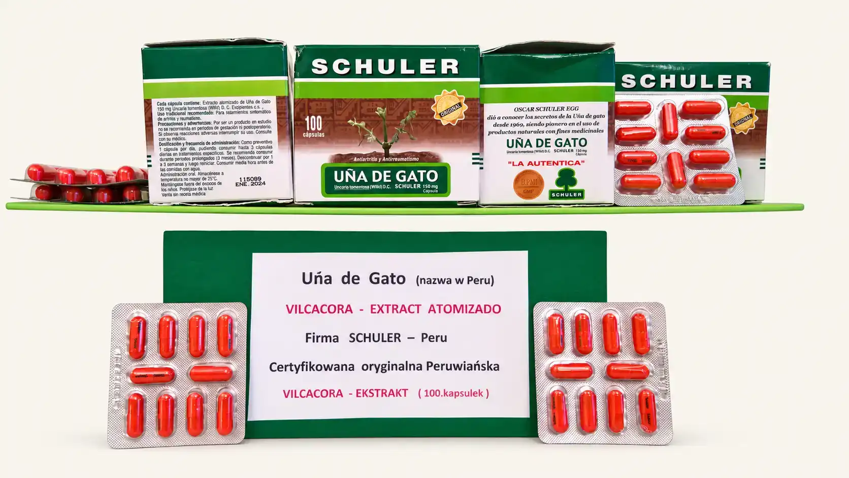 Uña de Gato firmy Schuler z Peru: opakowania po 100 kapsułek, blistry czerwonych kapsułek i tabliczka „Vilcacora – ekstrakt atomizado, certyfikowana oryginalna peruwiańska”